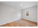 This bedroom features neutral walls, a wood floor, and a window for natural light at 4708 River Boat Landing Ct, Raleigh, NC 27604