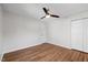 Bedroom features hardwood floors, a ceiling fan, a closet, and a door at 4708 River Boat Landing Ct, Raleigh, NC 27604
