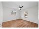 Bright bedroom with hardwood floors, a ceiling fan, and windows providing ample natural light at 4708 River Boat Landing Ct, Raleigh, NC 27604