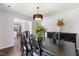 Traditional dining room with hardwood floors, dark furniture, and modern chandelier at 4708 River Boat Landing Ct, Raleigh, NC 27604