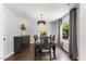 Dining room with wooden floors, elegant chandelier, and large window at 4708 River Boat Landing Ct, Raleigh, NC 27604