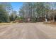 Community entrance with signage, landscaping and surrounding mature trees at 4708 River Boat Landing Ct, Raleigh, NC 27604