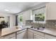Open concept kitchen with white cabinets and updated countertops at 4708 River Boat Landing Ct, Raleigh, NC 27604