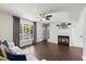 Comfortable living room featuring a fireplace, hardwood floors, and large windows at 4708 River Boat Landing Ct, Raleigh, NC 27604