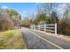 Asphalt path featuring a yellow center line and white fence near a bridge at 4708 River Boat Landing Ct, Raleigh, NC 27604
