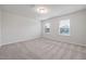 Bright bedroom with neutral carpeting and two large windows at 518 Donnegal Farm Dr, Fuquay Varina, NC 27526