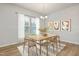 Bright dining room with hardwood floors and a wood table at 518 Donnegal Farm Dr, Fuquay Varina, NC 27526