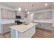 Modern kitchen with gray cabinets and granite island at 518 Donnegal Farm Dr, Fuquay Varina, NC 27526