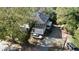 Two-story house, gray siding, with a gravel driveway and mature trees nearby at 603 W Davis St, Burlington, NC 27215