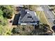Large home with a dark gray roof, surrounded by trees and a yard at 603 W Davis St, Burlington, NC 27215