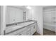 Bright Primary bathroom featuring double sinks with granite counters, a large mirror, and a shower and tub at 630 Contento Ct, Sanford, NC 27330