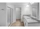 Bright Primary bathroom featuring double sinks with granite counters, a glass enclosed shower, and tile floors at 630 Contento Ct, Sanford, NC 27330