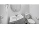 Bathroom featuring a pedestal sink, oval mirror, and toilet at 630 Contento Ct, Sanford, NC 27330