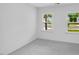 Bright bedroom featuring two large windows and neutral carpeting at 630 Contento Ct, Sanford, NC 27330