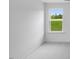 Carpeted bedroom featuring a large window with a green view at 630 Contento Ct, Sanford, NC 27330