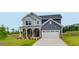 Charming two-story home with a covered porch and a two-car garage at 630 Contento Ct, Sanford, NC 27330