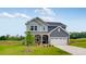 Charming two-story home with a covered porch, landscaped yard and a two-car garage at 630 Contento Ct, Sanford, NC 27330