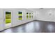 Open-concept living room with hardwood floors, white walls, a door to the back yard, and lots of natural light at 630 Contento Ct, Sanford, NC 27330