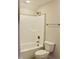 Bright bathroom featuring a shower-tub combo with tile surround and a modern toilet at 79 Surles Landing Way, Benson, NC 27504