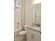 Well-lit bathroom featuring a granite vanity, sink, shower-tub combo, and tile flooring at 79 Surles Landing Way, Benson, NC 27504