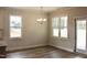 Light-filled dining room featuring hardwood floors, a chandelier, and access to the backyard at 79 Surles Landing Way, Benson, NC 27504
