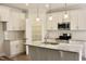 Modern kitchen with white cabinets, granite countertops, stainless steel appliances, and a pantry at 79 Surles Landing Way, Benson, NC 27504
