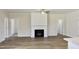 Bright living room features a fireplace, wood-look floors and a ceiling fan at 79 Surles Landing Way, Benson, NC 27504