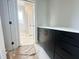 Bathroom area with stylish black cabinets and view into adjacent space at 130 Broadleaf Ln, Louisburg, NC 27549