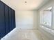 Bright bedroom featuring a modern accent wall and large windows providing ample natural light at 130 Broadleaf Ln, Louisburg, NC 27549