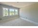 Bedroom featuring three large windows offering abundant natural light at 130 Broadleaf Ln, Louisburg, NC 27549