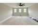 Bright bedroom with neutral walls, large windows, and a modern ceiling fan at 130 Broadleaf Ln, Louisburg, NC 27549