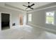 Bright bedroom with a modern ceiling fan, walk-in closet, and lots of natural light at 130 Broadleaf Ln, Louisburg, NC 27549