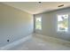 Bedroom with two windows allowing for natural light and a scenic view at 130 Broadleaf Ln, Louisburg, NC 27549