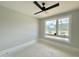 A room with a ceiling fan and large window, offering a view of a lush green field at 130 Broadleaf Ln, Louisburg, NC 27549