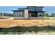 New construction two-story home with gray siding and black trim in a suburban neighborhood at 130 Broadleaf Ln, Louisburg, NC 27549