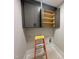 Laundry room with overhead cabinets and a ladder at 130 Broadleaf Ln, Louisburg, NC 27549