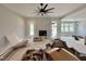 Open-concept living room features a sleek black ceiling fan, fireplace and french doors at 130 Broadleaf Ln, Louisburg, NC 27549