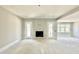Open living area with fireplace and access to the outdoor space via double doors at 130 Broadleaf Ln, Louisburg, NC 27549