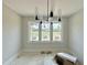 Sunlit living room features large windows, offering picturesque outdoor views of trees at 130 Broadleaf Ln, Louisburg, NC 27549
