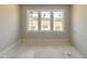 Bright room with base trim featuring three windows providing natural light at 130 Broadleaf Ln, Louisburg, NC 27549