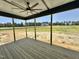 Covered back porch with ceiling fan overlooking a large backyard under construction at 130 Broadleaf Ln, Youngsville, NC 27596