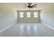 A large bedroom with three white-framed windows lined across a back wall providing great natural light at 130 Broadleaf Ln, Youngsville, NC 27596