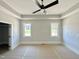 Bedroom with trey ceilings, windows, ceiling fan, and closet at 130 Broadleaf Ln, Youngsville, NC 27596