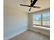 A neutrally-toned bedroom featuring a modern ceiling fan and a white-framed window offering natural lighting at 130 Broadleaf Ln, Youngsville, NC 27596