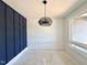 Dining room featuring a stylish light fixture and a paneled accent wall at 130 Broadleaf Ln, Youngsville, NC 27596