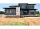 Modern home with gray siding, large windows, and clean lines at 130 Broadleaf Ln, Youngsville, NC 27596