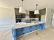 Kitchen with a large island, modern appliances, and gray cabinetry at 130 Broadleaf Ln, Youngsville, NC 27596