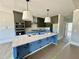 Bright kitchen with island, stainless appliances, and pendant lighting at 130 Broadleaf Ln, Youngsville, NC 27596