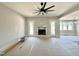 Large living room with a fireplace and modern ceiling fan at 130 Broadleaf Ln, Youngsville, NC 27596