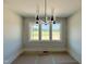 Well-lit room with a modern chandelier and large windows at 130 Broadleaf Ln, Youngsville, NC 27596